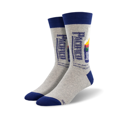 Pair of grey crew socks with a navy blue cuff.  The socks feature a retro-style Pacifico beer bottle graphic.
