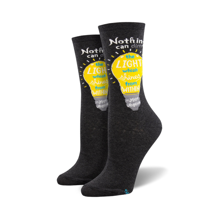 Pair of dark gray crew socks with a yellow lightbulb graphic and a Maya Angelou quote: