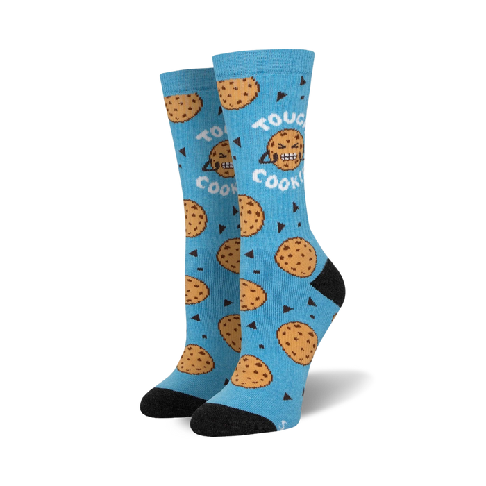 Pair of crew socks; light blue with chocolate chip cookies and grumpy cookie faces; black heel and toe.