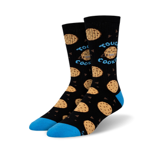 black crew socks feature a pattern of big, gooey, blue-eyed chocolate chip cookies with a smiley face. words 