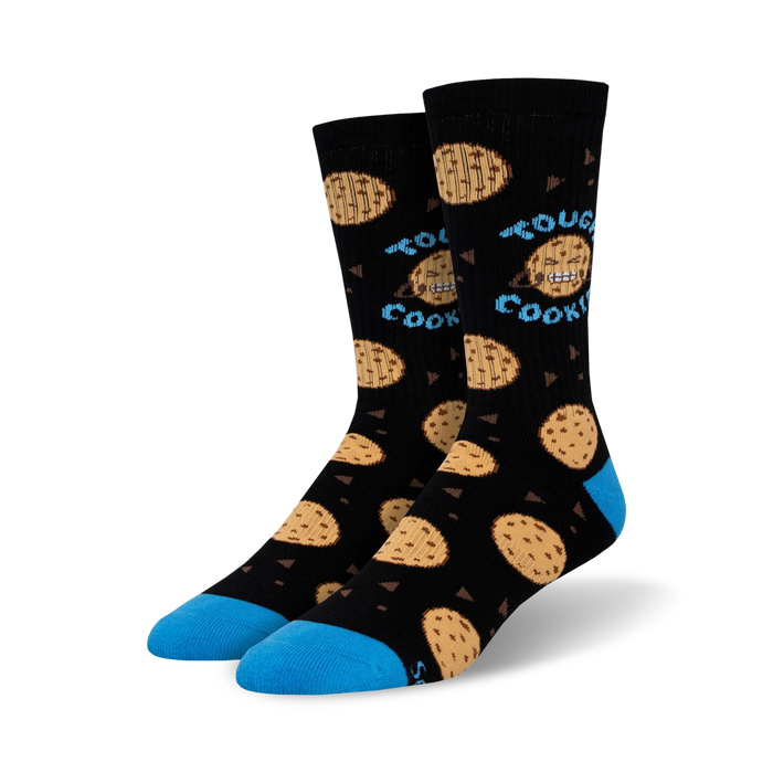 black crew socks feature a pattern of big, gooey, blue-eyed chocolate chip cookies with a smiley face. words 