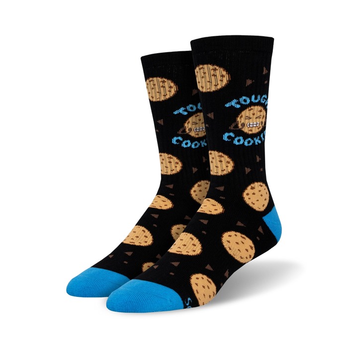 Lifestyle shot of Tough Cookie socks on a person's feet; the socks are black with blue cuffs and chocolate chip cookie designs.