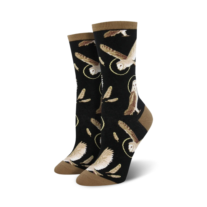 Pair of women's crew socks. Black background with brown owls in flight and feathers. Tan-colored cuff. }}