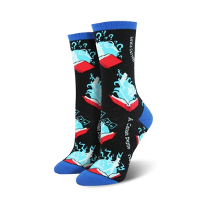 Close-up of a pair of black and blue 'Book Your Adventure' crew socks. The socks feature a design of a book with magical elements.