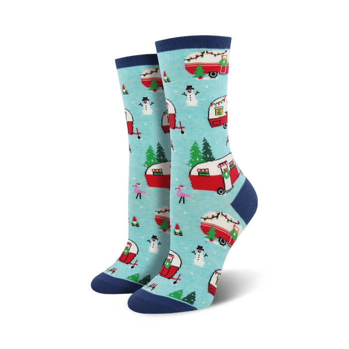 Pair of crew socks in teal and navy blue. Features a pattern of red camper vans decorated for Christmas, snowmen, and pink flamingos.