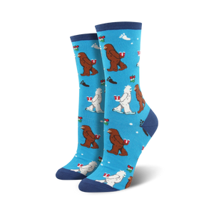 Crew socks in blue, green, and red featuring Bigfoot and Yeti characters carrying gifts on a snowflake background.