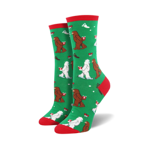 Close-up of a green Mythical Kissmas sock with red cuff, showing the Bigfoot and Yeti design detail.