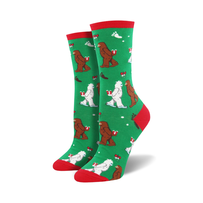 green crew socks with cartoon abominable snowmen wearing santa hats and carrying gifts, red snowflakes on background.  