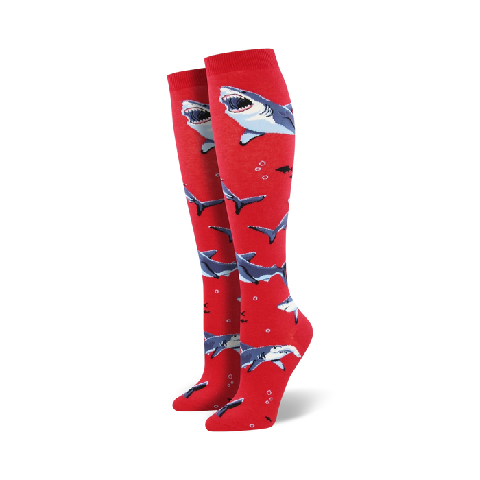 Pair of red knee-high socks with a pattern of gray sharks and small bubbles. Fun and playful design. }}