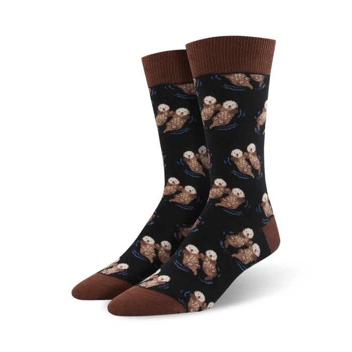 Pair of crew socks; black background with repeating pattern of brown otters swimming; brown cuff.