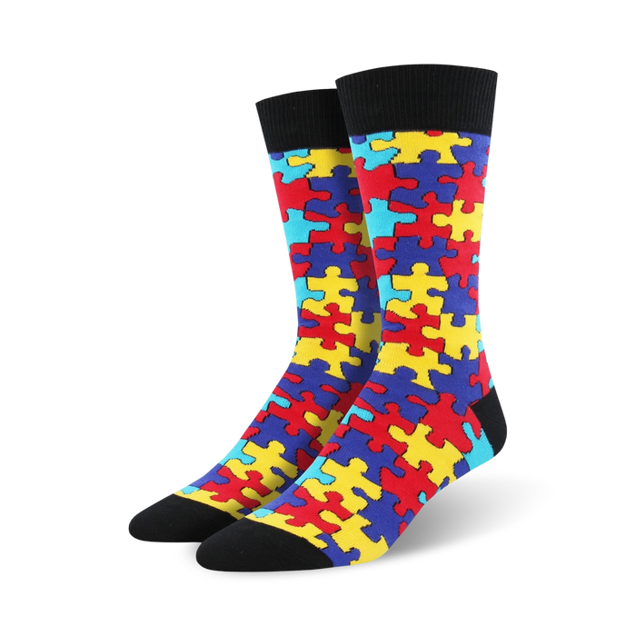 Pair of crew socks with a puzzle-piece design. The socks are predominantly red, yellow, blue, and teal. }}