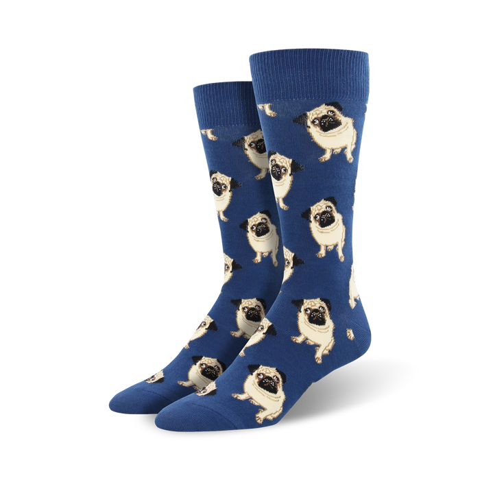 Pair of men's blue crew socks covered in a repeating pattern of tan pugs. The pugs are facing forward in various poses. }}