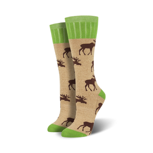 Lifestyle shot of Outlands Moose socks in tan and green. They're shown on a model's feet, worn casually.