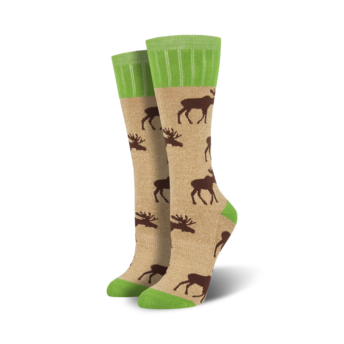 Lifestyle shot of Outlands Moose socks in tan and green. They're shown on a model's feet, worn casually.