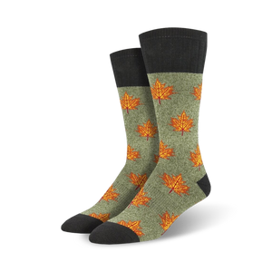 Pair of crew socks in olive green with orange maple leaf pattern and dark gray cuffs. Autumn-themed design.