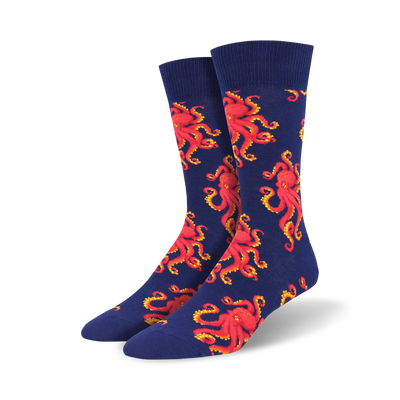 Pair of crew socks with a navy blue background and repeating red octopus designs. Fun and playful!