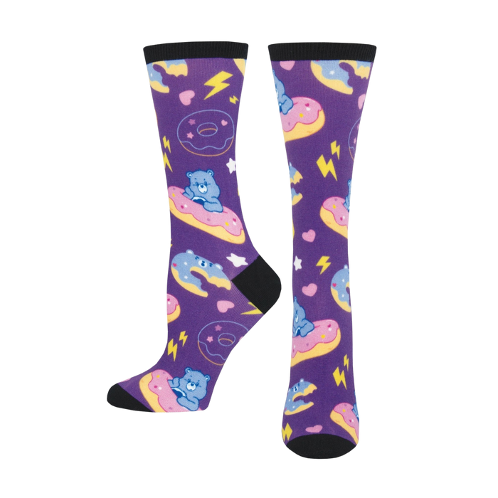 A pair of purple crew socks with Grumpy Bear from Care Bears riding pastel donuts. Lightning bolts and hearts complete the fun design. }}
