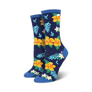Pair of women's crew socks in navy blue, featuring yellow and orange hibiscus flowers and green leaves.  Blue cuffs.