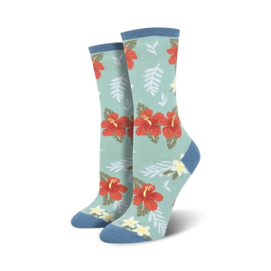 Close-up showing the detail of the red hibiscus flower and green leaf design on a teal crew sock.