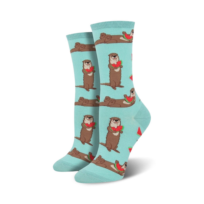 A pair of women's crew socks in teal. Otters holding watermelon slices are playfully printed against a light teal background. }}
