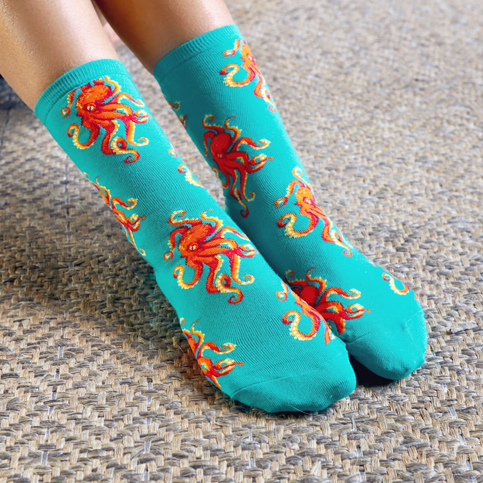 Close-up of teal crew socks with red octopus design.