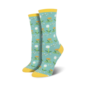 Pair of crew socks, teal background with white dandelions and yellow accents. Yellow cuff.