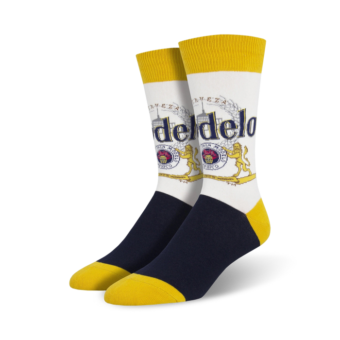Pair of crew socks; white background with Modelo beer logo in gold, red, and blue; navy blue and yellow accents. }}