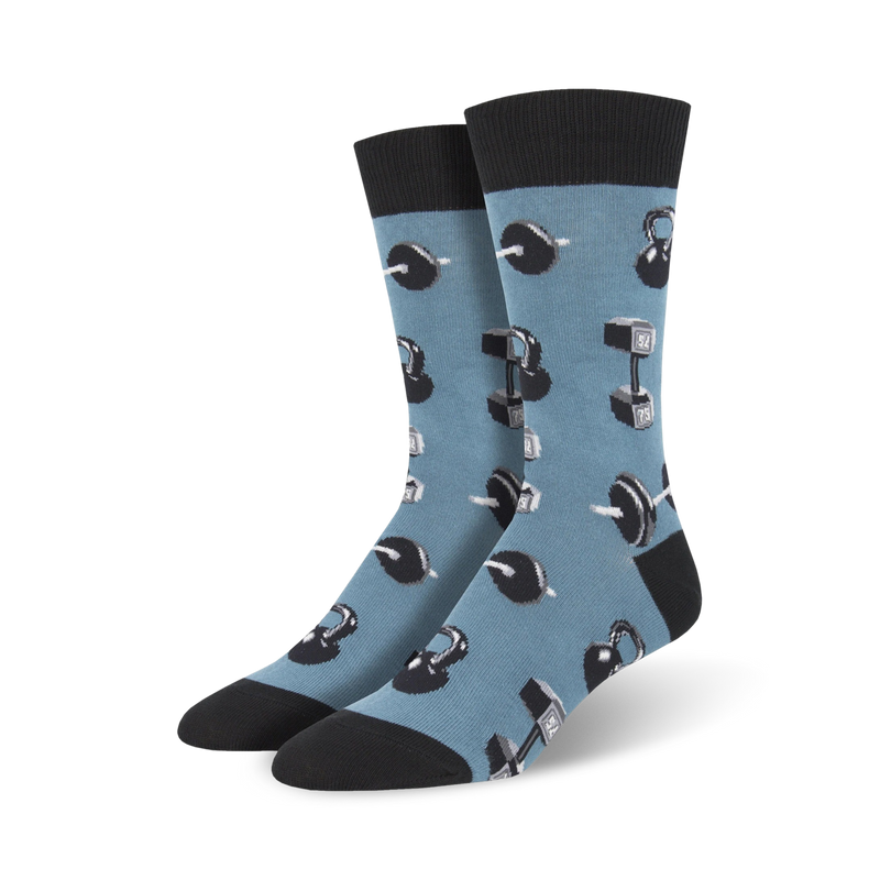 A pair of men's crew socks in blue with a pattern of grey kettlebells and dumbbells. Black cuffs complete the look.
