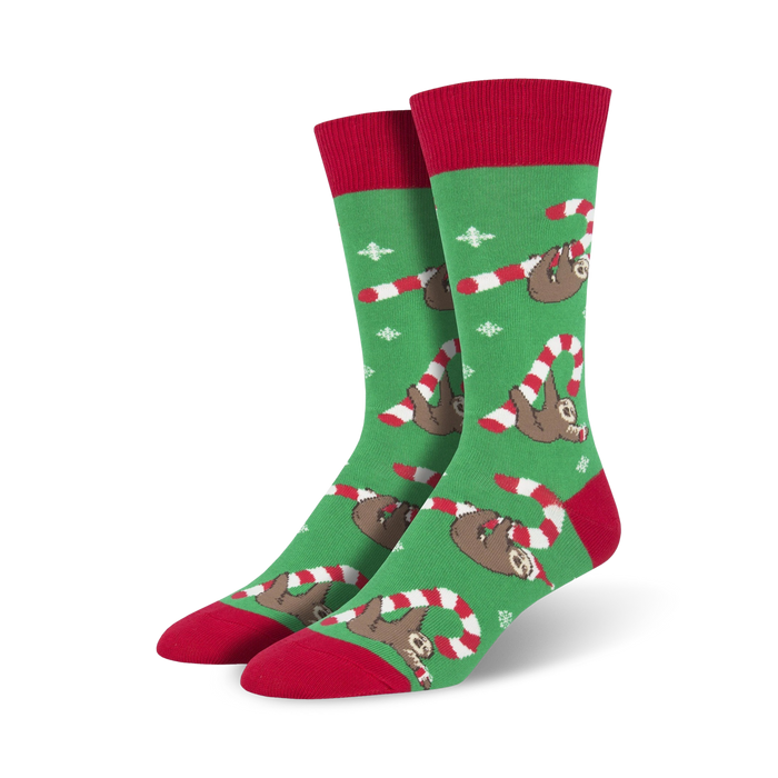 Pair of crew socks; green and red with sloths hanging from candy canes; whimsical Christmas design.