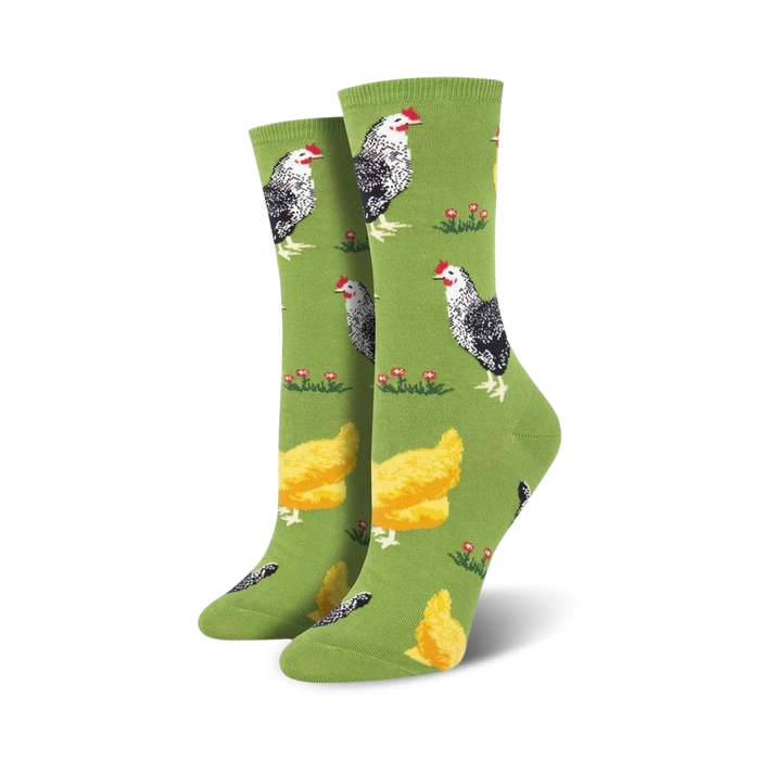 Pair of women's crew socks, green and blue options, featuring a repeating pattern of black and white chickens and yellow chicks on a grassy field.