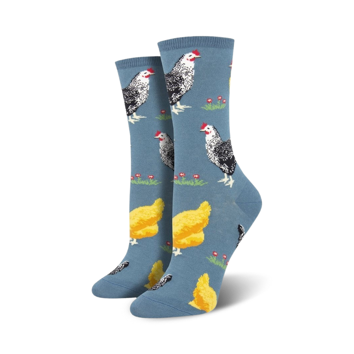 Lifestyle shot of a person's feet wearing the blue chicken socks. They're walking on a light wooden floor.