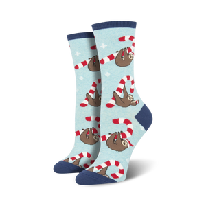 Lifestyle flat lay photo showing a pair of light blue Merry Slothmas socks surrounded by candy canes shaped into hearts.