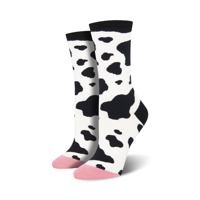 Pair of women's crew socks in a black and white cow print. The toes are a light pink color. }}