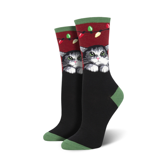Lifestyle shot showing the socks on a person's feet, highlighting the festive design and cat illustration.