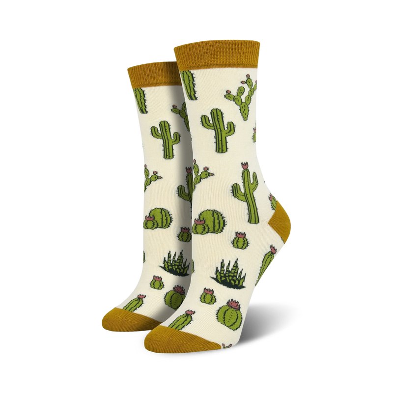 Pair of cream crew socks with a repeating pattern of green cacti and pink flowers. The socks have a mustard yellow cuff.