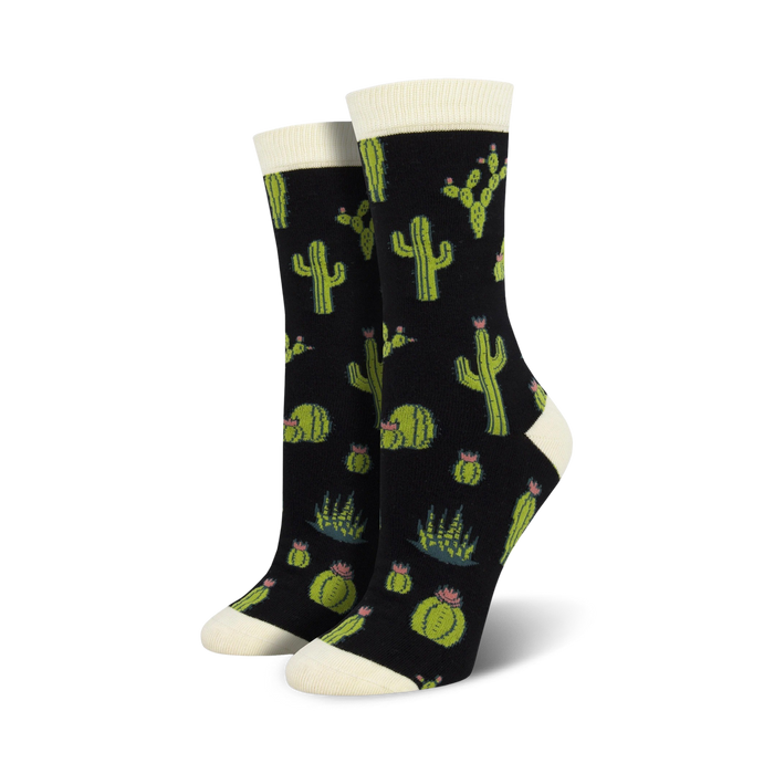 A pair of women's crew socks with a cactus design. The socks are black with green cacti, succulents, and pink flowers. }}