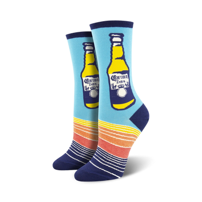 Pair of women's crew socks. Light blue background, navy blue and orange stripes at the bottom.  A Corona Extra beer bottle is prominently displayed.