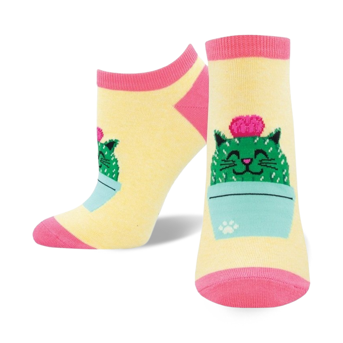 Pair of pastel yellow ankle socks with a cute cartoon cactus cat design. Pink and teal accents.