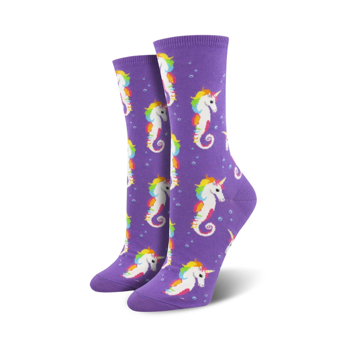 Pair of women's crew socks. Purple background with repeating pattern of rainbow-maned seahorse unicorns and small bubbles. }}