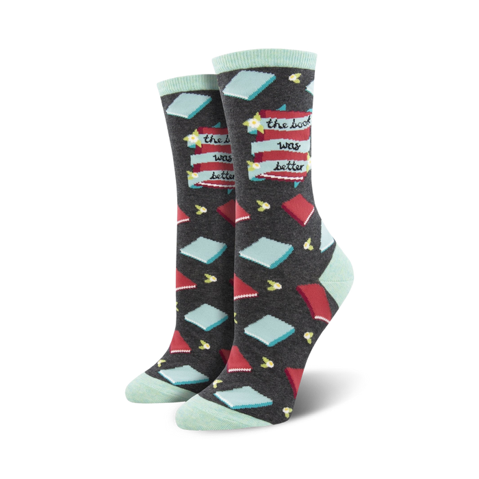 Pair of dark gray crew socks with red and teal book illustrations and the phrase 'The Book Was Better'.