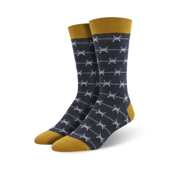 Pair of men's crew socks. Navy blue with grey barbed wire pattern and mustard yellow cuff. }}