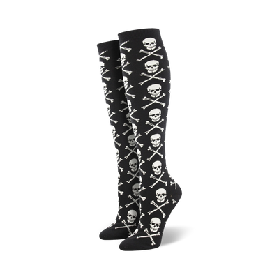 Pair of black knee-high socks with a repeating pattern of white skulls and crossbones.