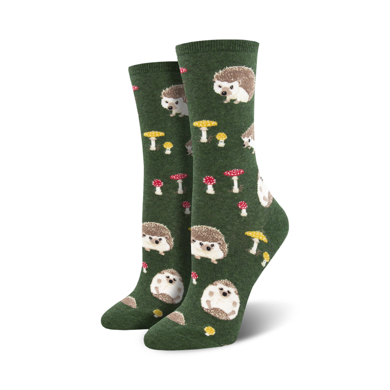Pair of women's crew socks in green and burgundy. Feature a whimsical pattern of hedgehogs and mushrooms.