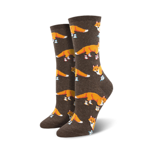 Pair of women's crew socks. Brown background with orange foxes wearing blue boots.  Fun, whimsical design.