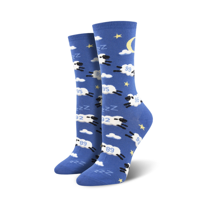 Pair of crew socks in blue with white clouds, stars, a crescent moon, and black sheep jumping. The sheep have 'Zzz' above them. }}