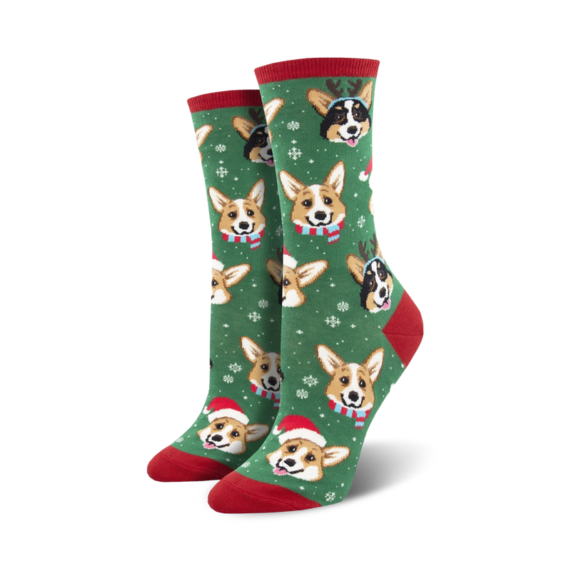 Pair of crew socks; green background with festive Corgis wearing Santa hats and reindeer antlers; snowflakes for a holiday feel.
