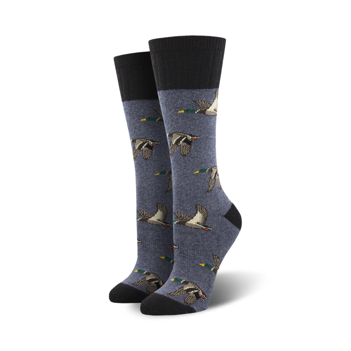 dark blue crew socks feature a pattern of flying brown and teal ducks.  
