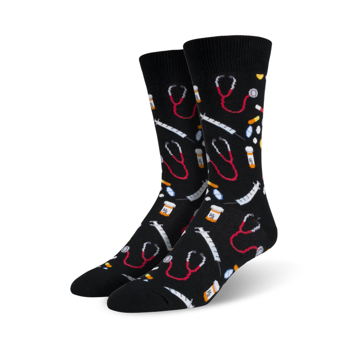 A pair of black crew socks with a fun pattern. The design includes red stethoscopes, syringes, and pills on a black background. }}