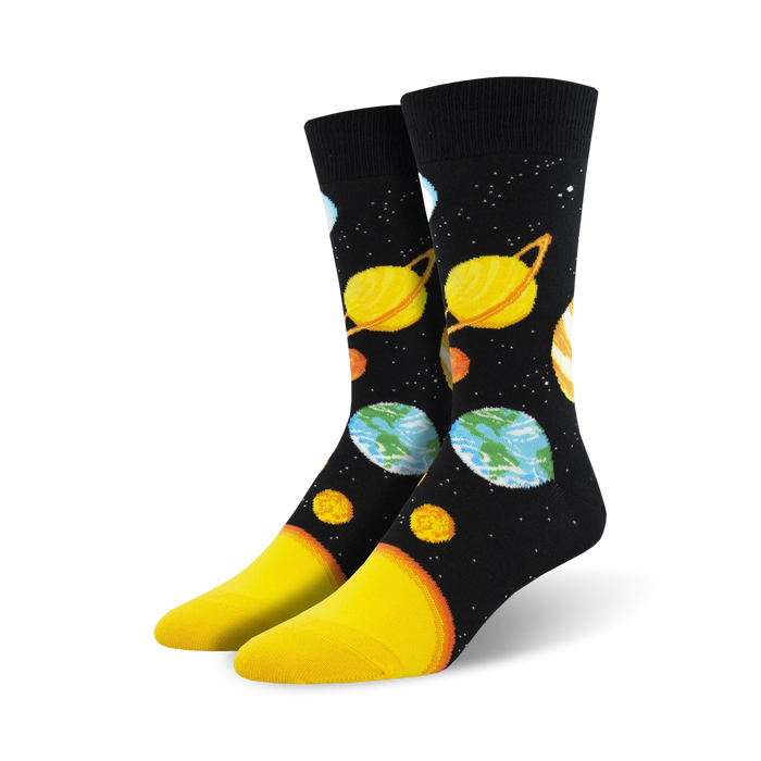 Pair of crew socks with a black background showcasing colorful planets and stars. A fun, cosmic design. }}