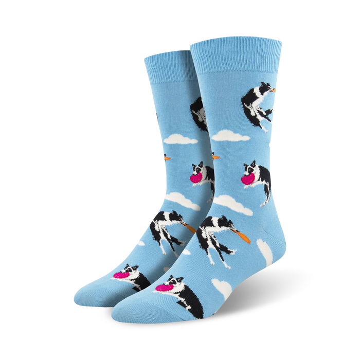 A pair of crew socks in light blue.  The design features black and white border collies catching pink frisbees against a cloudy sky. }}